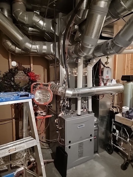 Boiler and ductwork in a finished basement mechanical room