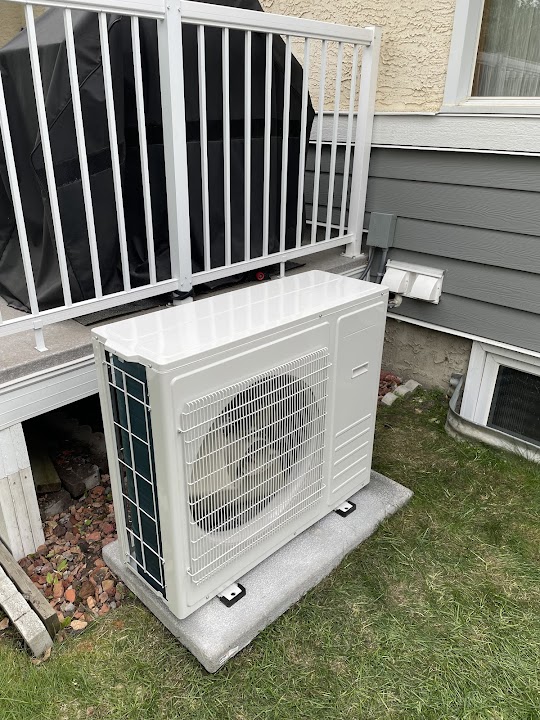 Cold-climate heat pump installed beside a Calgary home